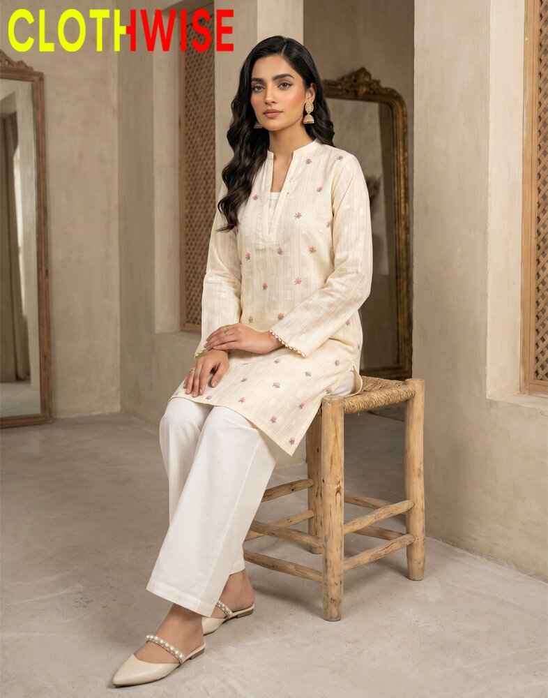 Woman in a white traditional outfit sitting on a wooden stool with 'CLOTHWISE' branding.