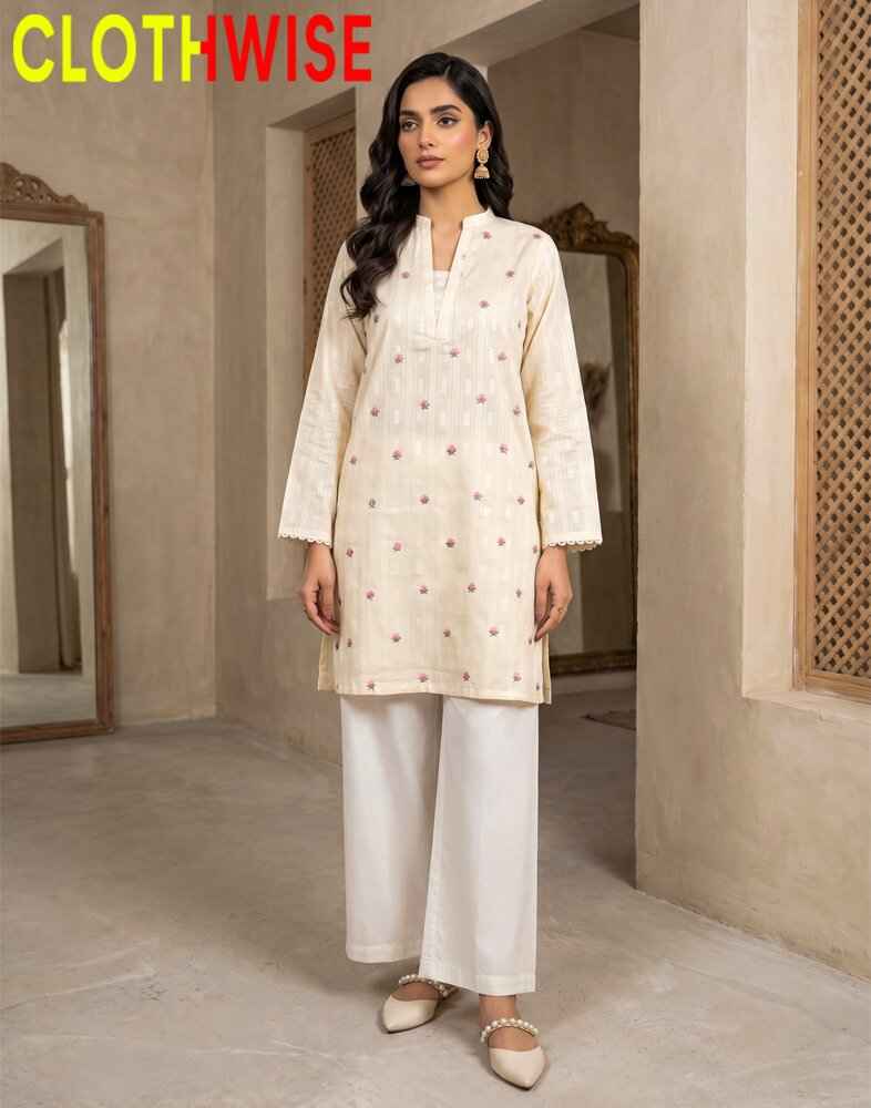 Woman wearing a cream kurta with white pants in a neutral-colored room.