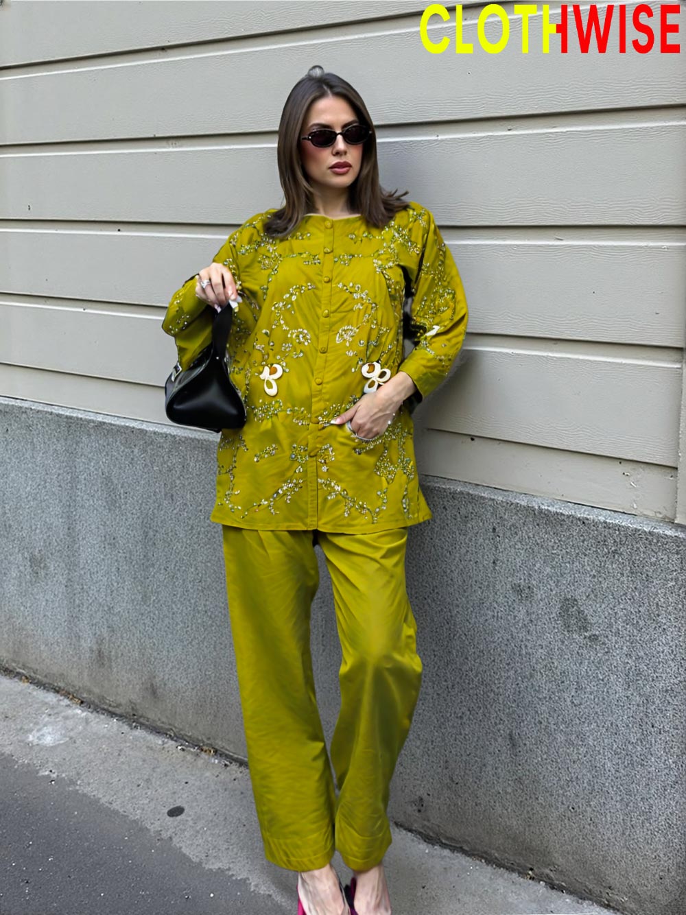 Woman in a green outfit standing against a gray wall with 'ClothWise' branding.