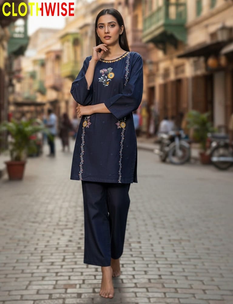 Woman in a navy blue outfit with embroidery standing on a street, with 'CLOTHWISE' branding.