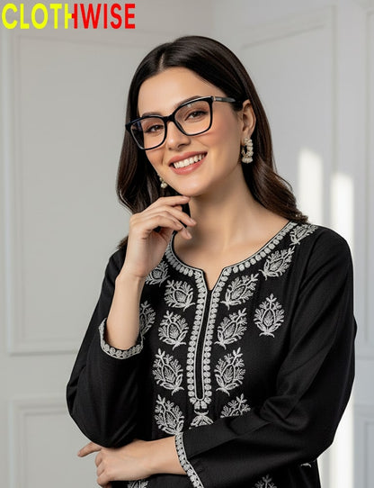 Woman wearing a black embroidered top with a white background, featuring the brand 'CLOTHWISE'.