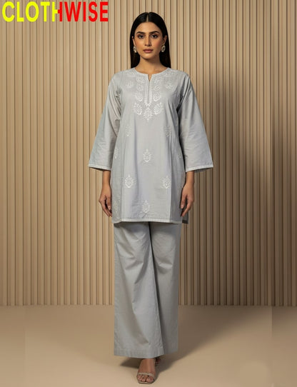 Woman wearing a light gray traditional outfit with floral patterns against a beige background, branded 'CLOTHWISE'.