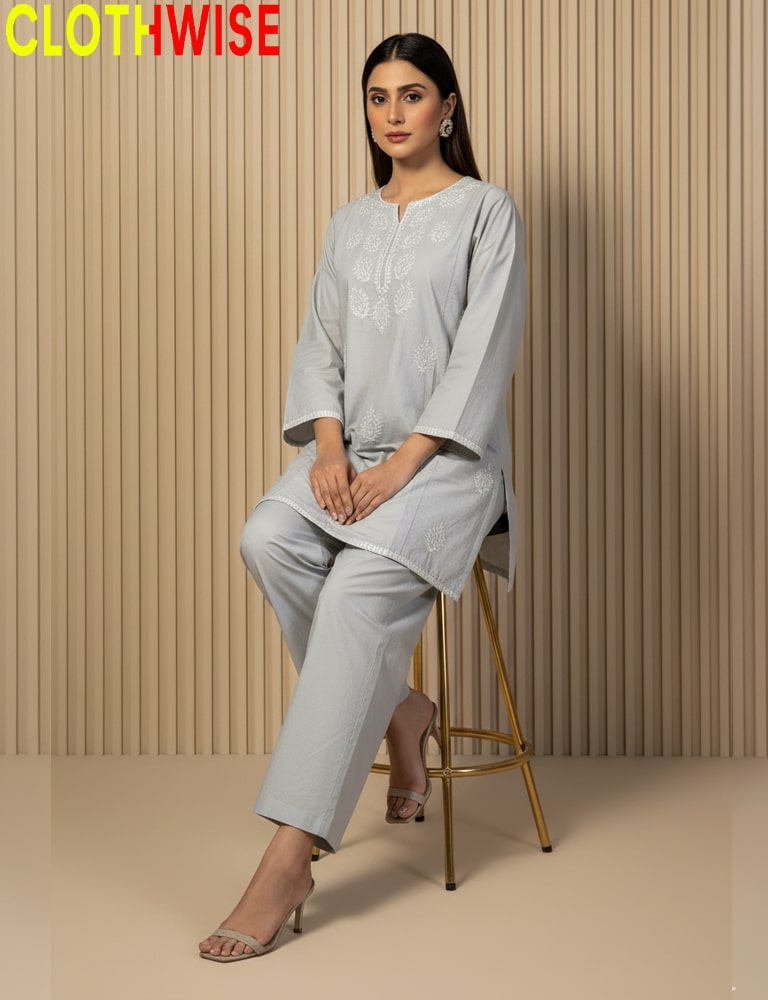 Woman wearing a light gray outfit sitting on a stool against a beige wall with 'CLOTHWISE' branding.