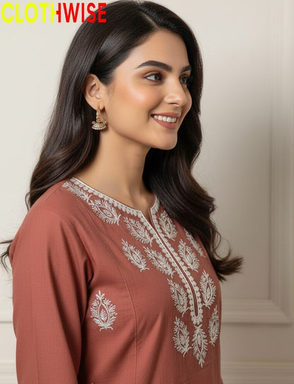 Woman wearing a brown embroidered top with 'CLOTHWISE' branding.