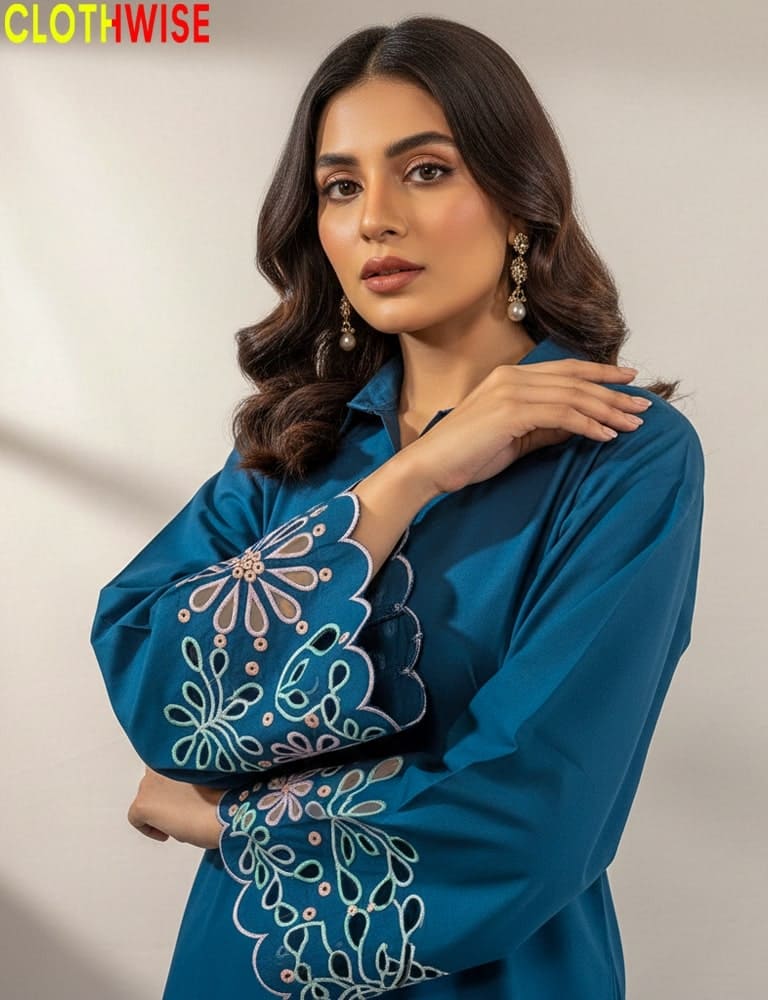 Woman wearing a blue embroidered dress with 'CLOTHWISE' branding.