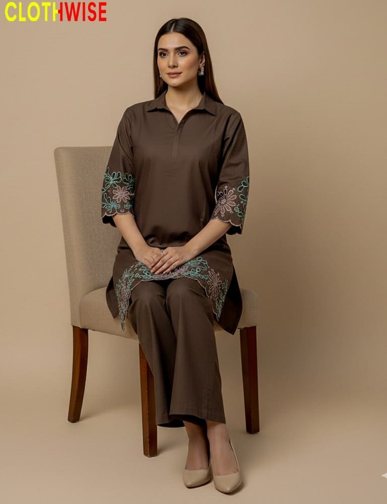Woman wearing a brown outfit with floral embroidery sitting on a chair, branded 'Clothwise'.