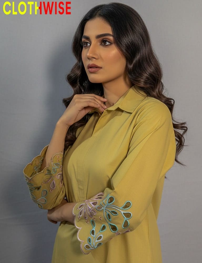 Woman wearing a yellow outfit with floral embroidery, branded 'Clothwise'.