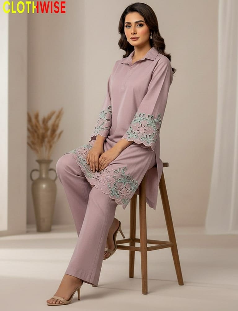 Woman in a light pink outfit with floral embroidery sitting on a stool, with 'Clothwise' branding.