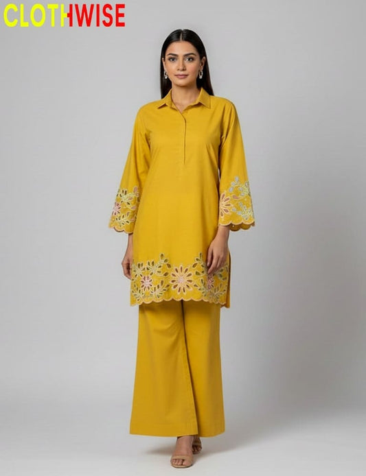 Woman wearing a yellow outfit with floral embroidery, branded 'CLOTHWISE'.