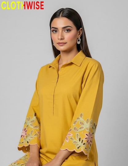 Woman wearing a yellow dress with floral embroidery, branded 'CLOTHWISE'.