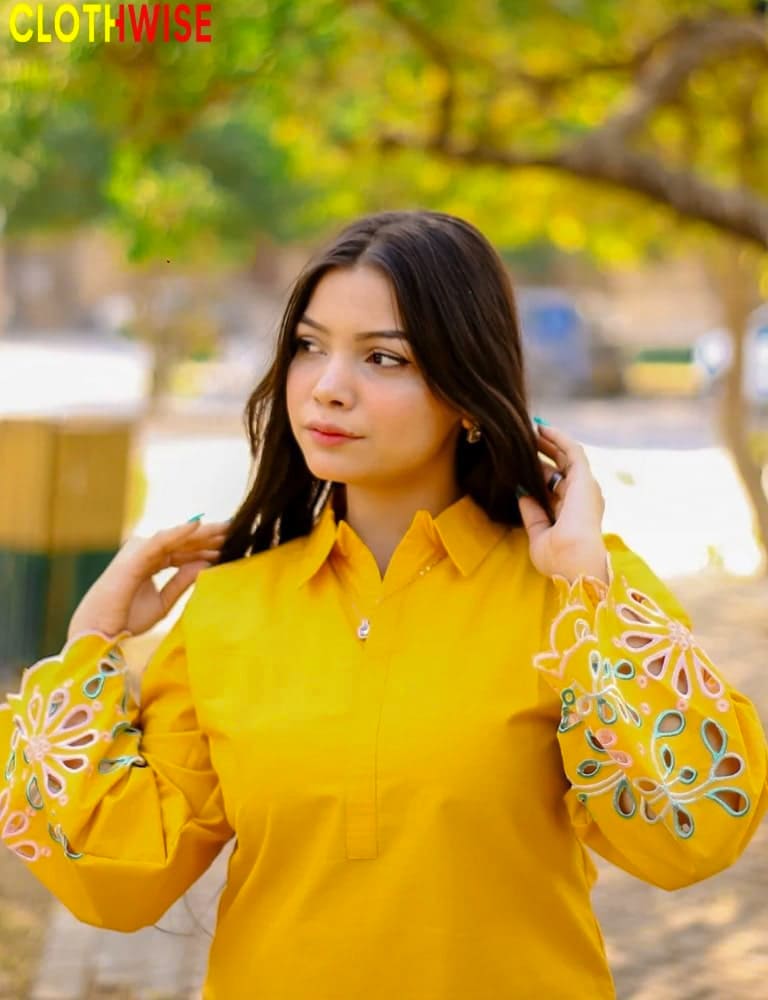 Woman wearing a yellow outfit with floral patterns outdoors, branded 'Clothwise'.