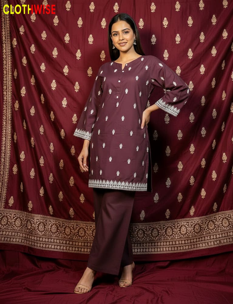 Woman wearing a maroon traditional outfit with white patterns against a matching fabric background, featuring the brand 'Clothwise'.
