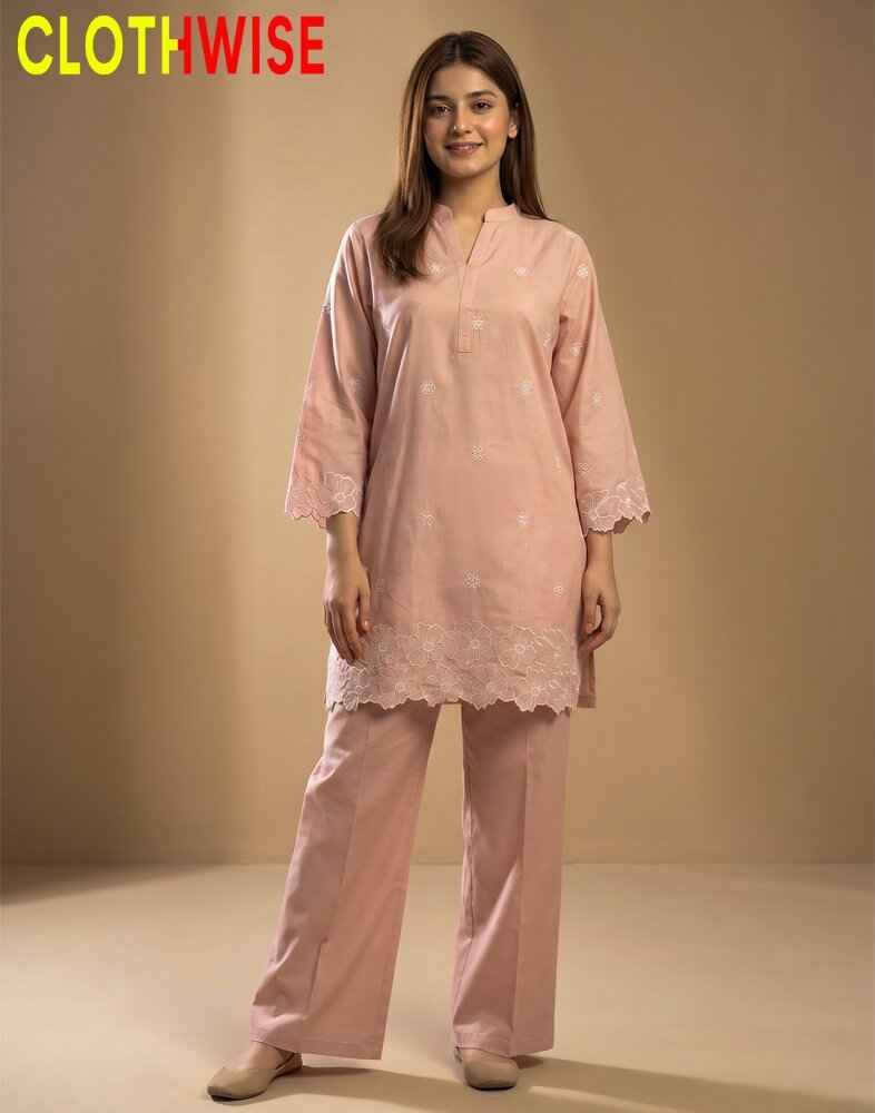 Woman wearing a pink outfit with lace details, standing against a beige background with 'CLOTHWISE' branding.