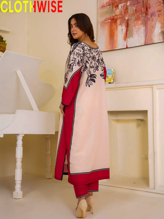 Woman wearing a red and white outfit with floral patterns in a room with a piano and abstract painting.