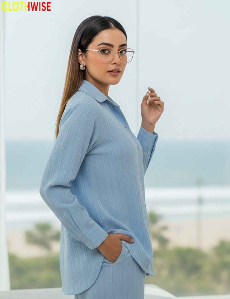 Woman wearing a light blue outfit with a blurred outdoor background