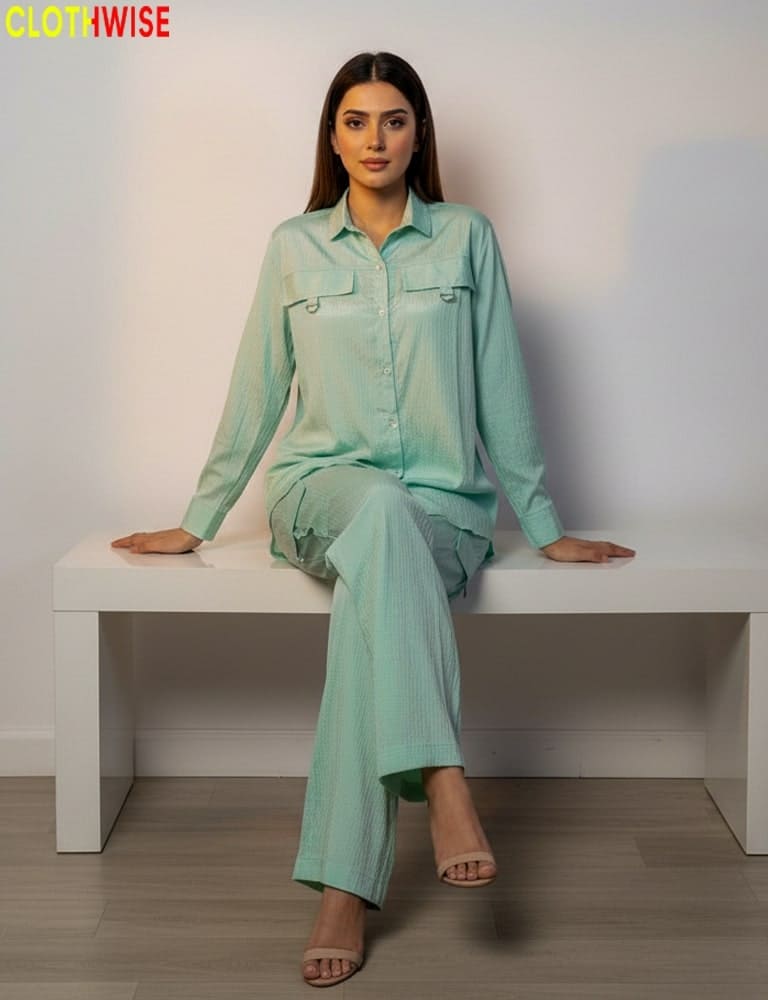 Woman in a mint green outfit sitting on a white bench with 'CLOTWWISE' branding.