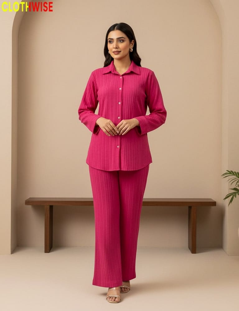 Woman wearing a pink outfit standing against a beige background with 'CLOTHWISE' branding.