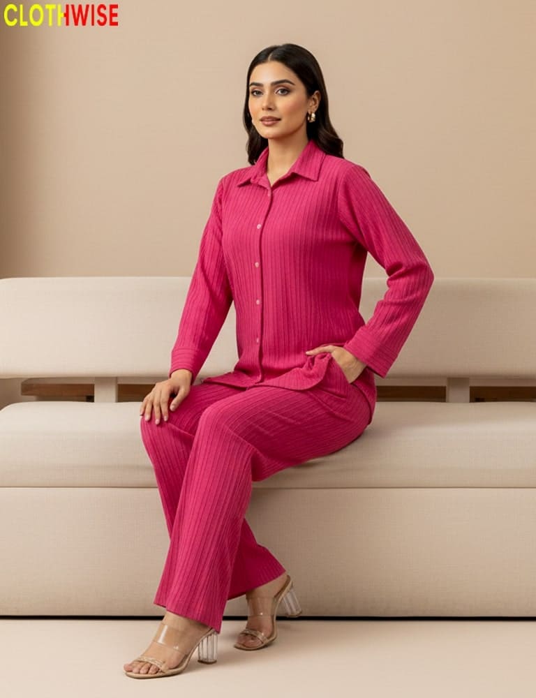 Woman in a pink outfit sitting on a beige couch with 'CLOTHWISE' branding.