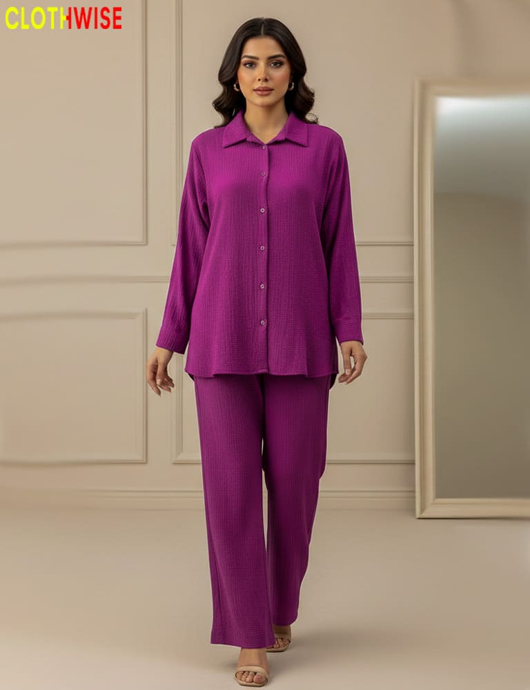 Woman wearing a purple outfit with a beige wall and mirror in the background, branded 'Clothwise'.