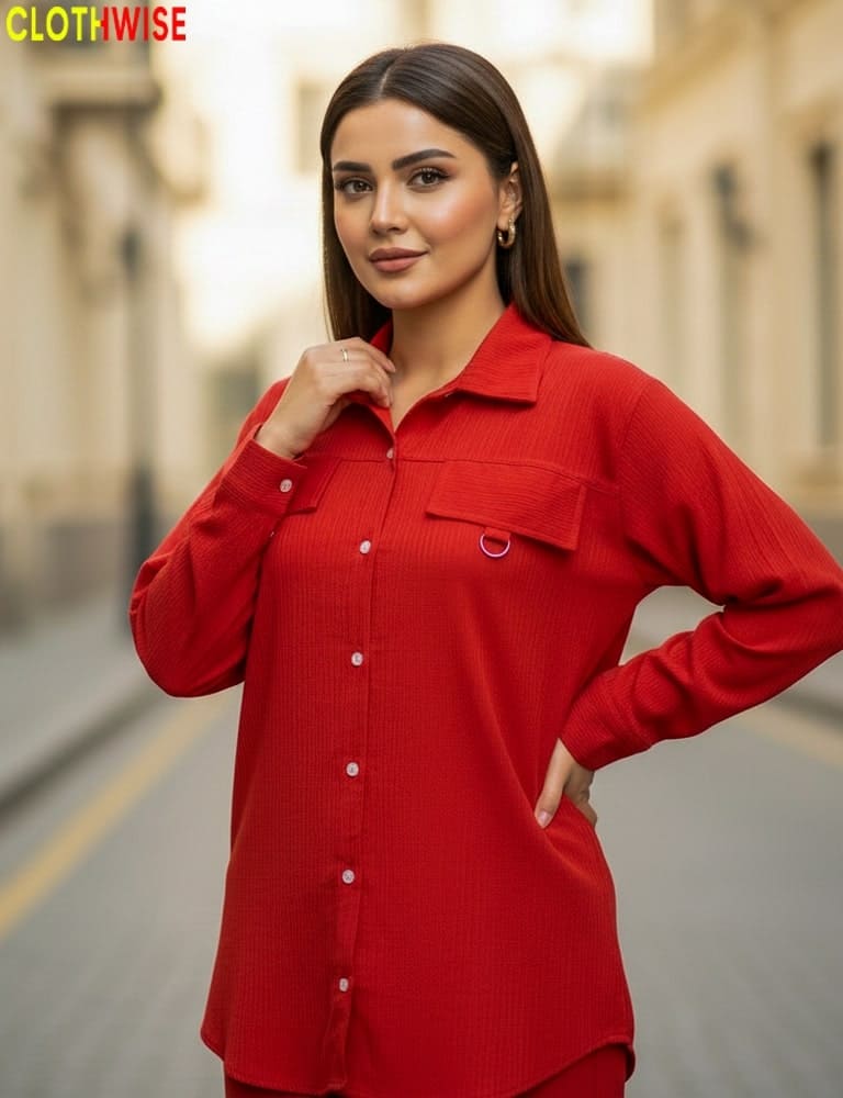 Woman wearing a red shirt standing on a street with a blurred background