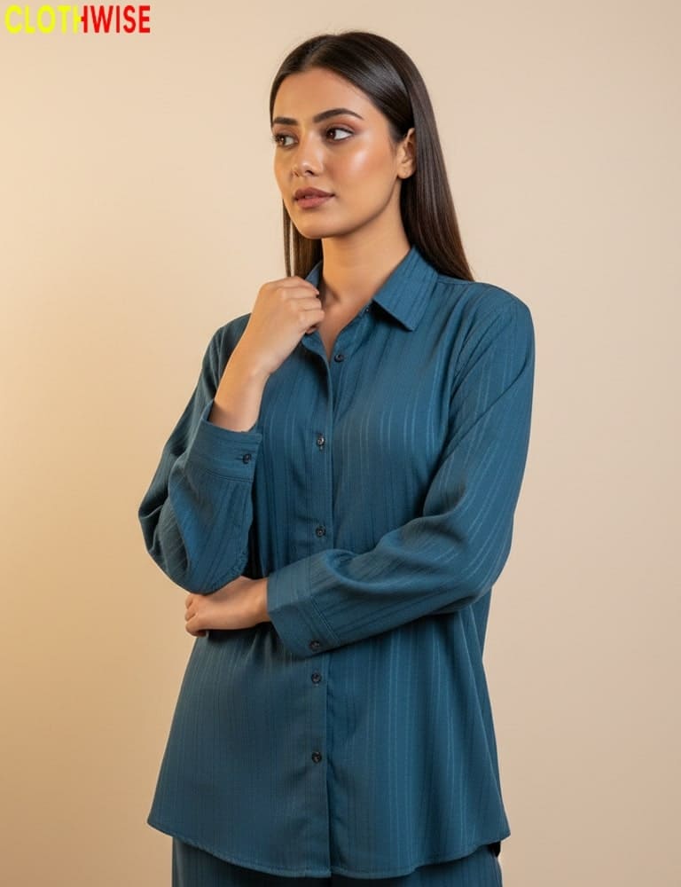 Woman wearing a teal shirt against a beige background