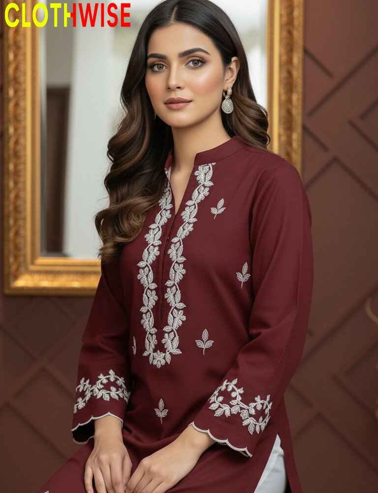 Woman wearing a maroon embroidered kurta with a gold frame in the background