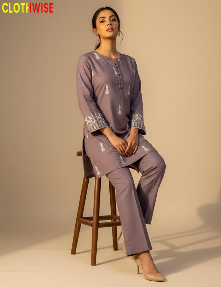 Woman wearing a matching set of top and pants with 'Clothwise' branding.