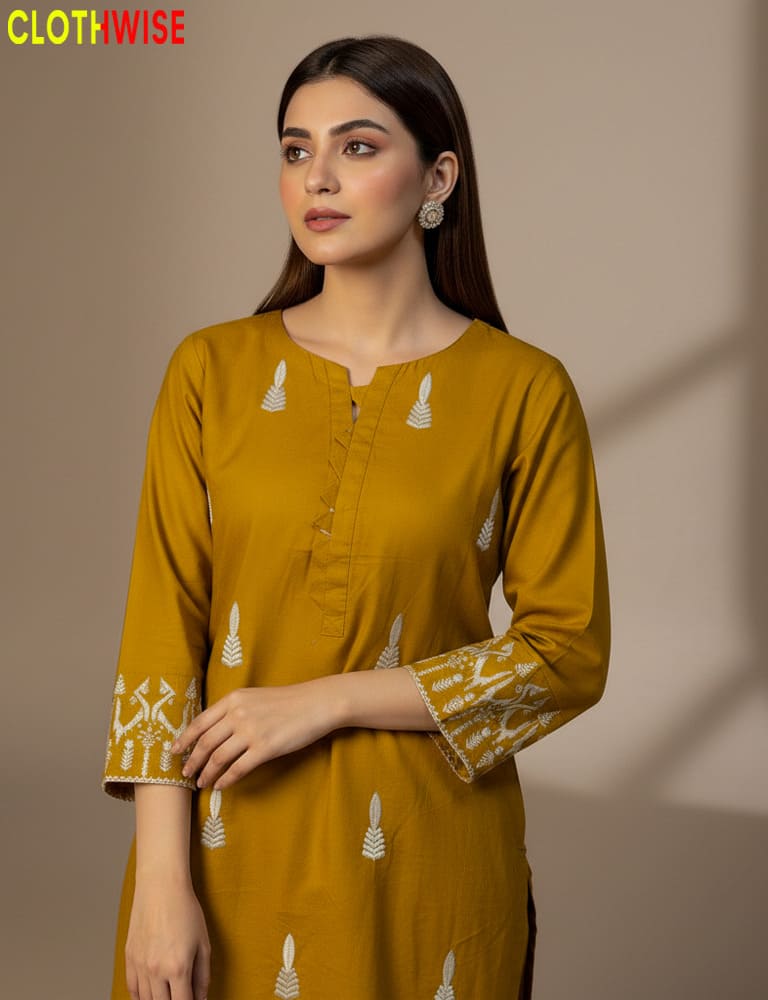 Woman wearing a mustard yellow kurta with white patterns on a beige background, branded 'Clothwise'.