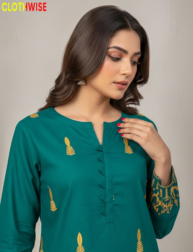 Woman wearing a green embroidered top with gold details, branded 'Clothwise'.