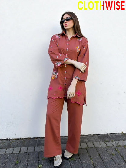 Woman wearing a rust-colored outfit with floral patterns against a white wall, branded 'ClothWise'.