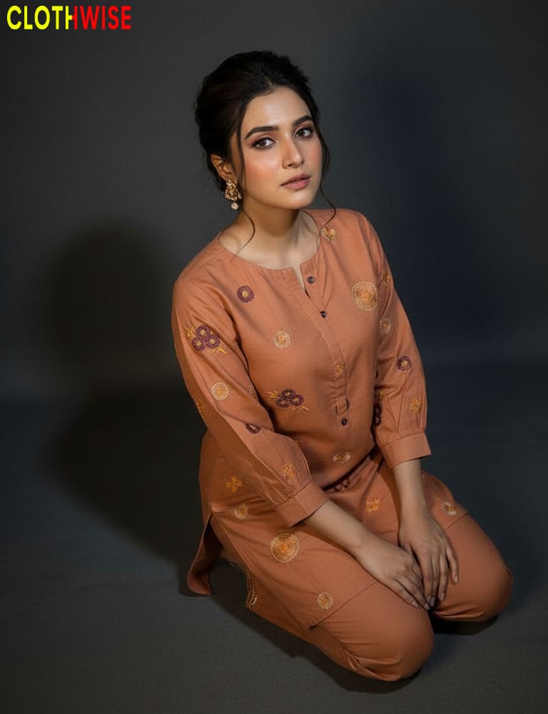 Woman wearing a brown outfit with floral patterns on a dark background, branded 'ClothWise'.