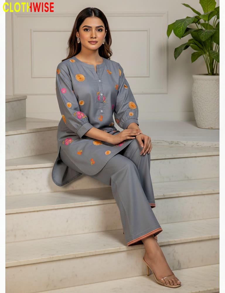 Woman sitting on steps wearing a gray outfit with floral patterns, brand 'ClothWise' visible.