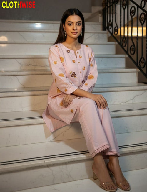 Woman in a pink outfit sitting on a staircase with 'ClothWise' branding.