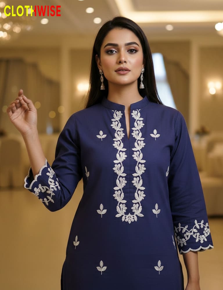 Woman wearing a blue embroidered dress in an indoor setting with 'Clothwise' branding.