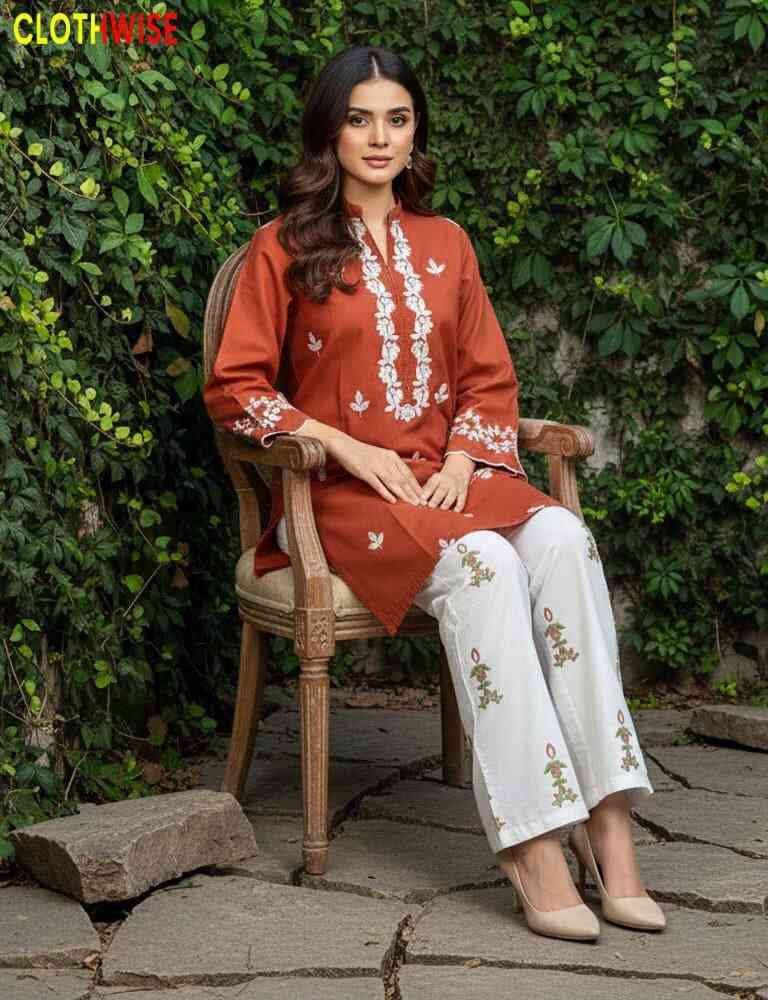 Woman in traditional outfit sitting on a chair with greenery in the background