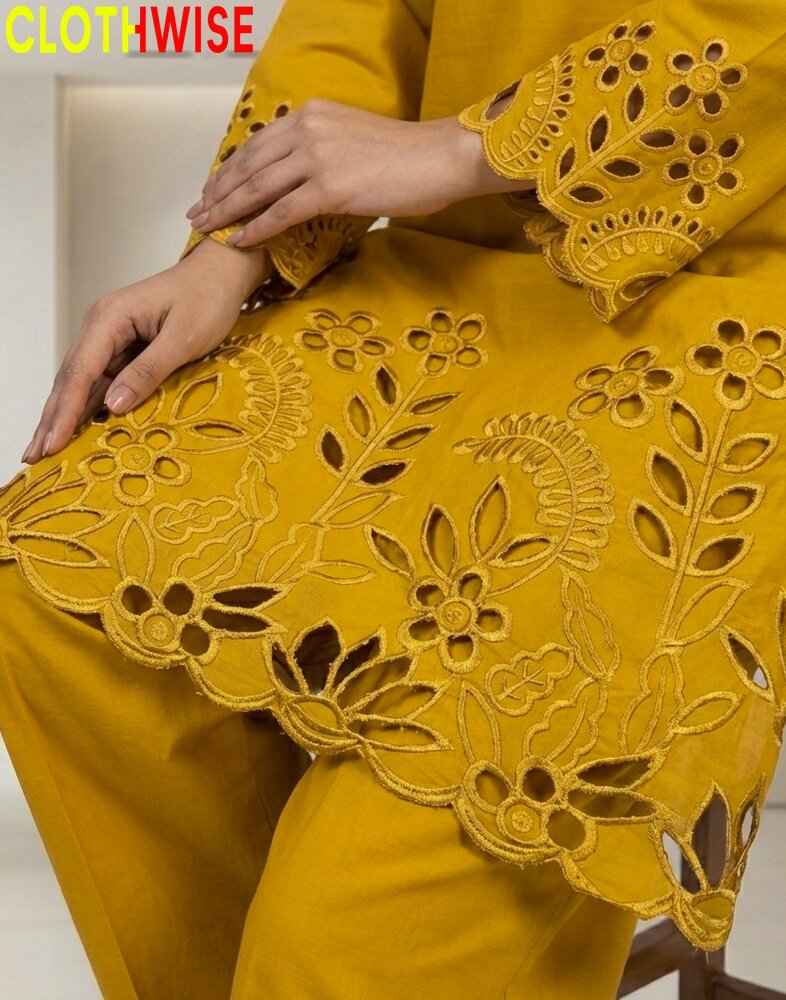 Yellow outfit with intricate cut-out patterns on a chair.