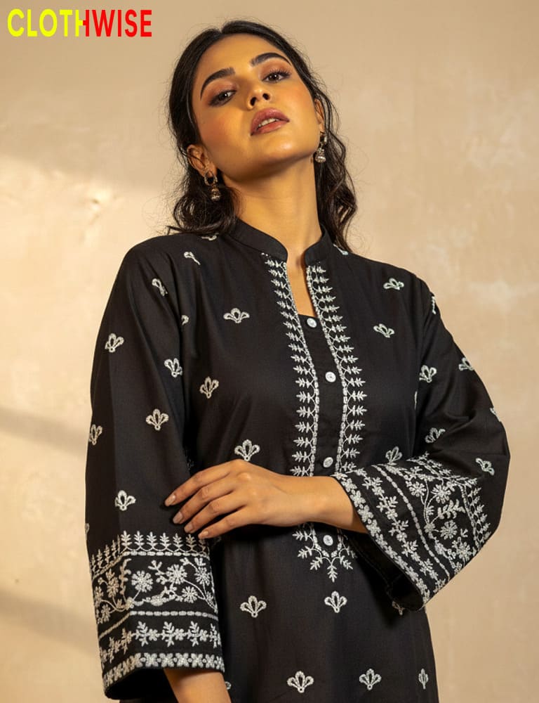 Woman wearing a black embroidered outfit with 'ClothWise' branding.