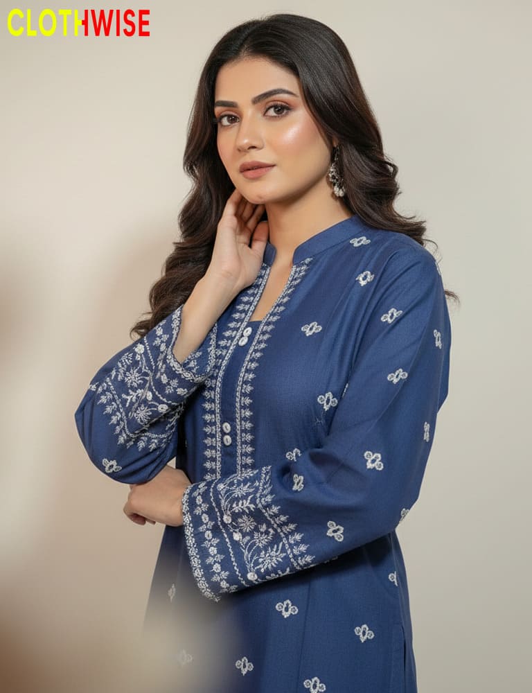 Woman wearing a blue embroidered outfit with 'Clothwise' branding.