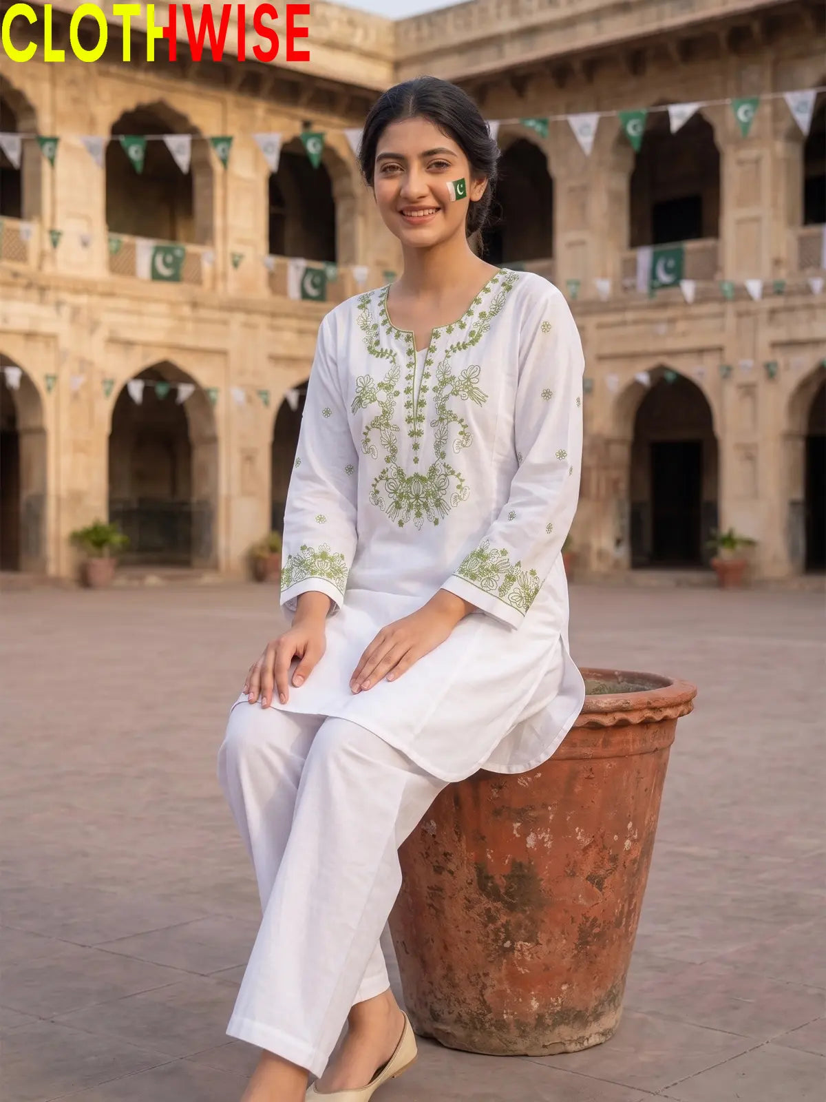 Model sitting in Azadi Parrot Motif Embroidered 2-piece lawn suit