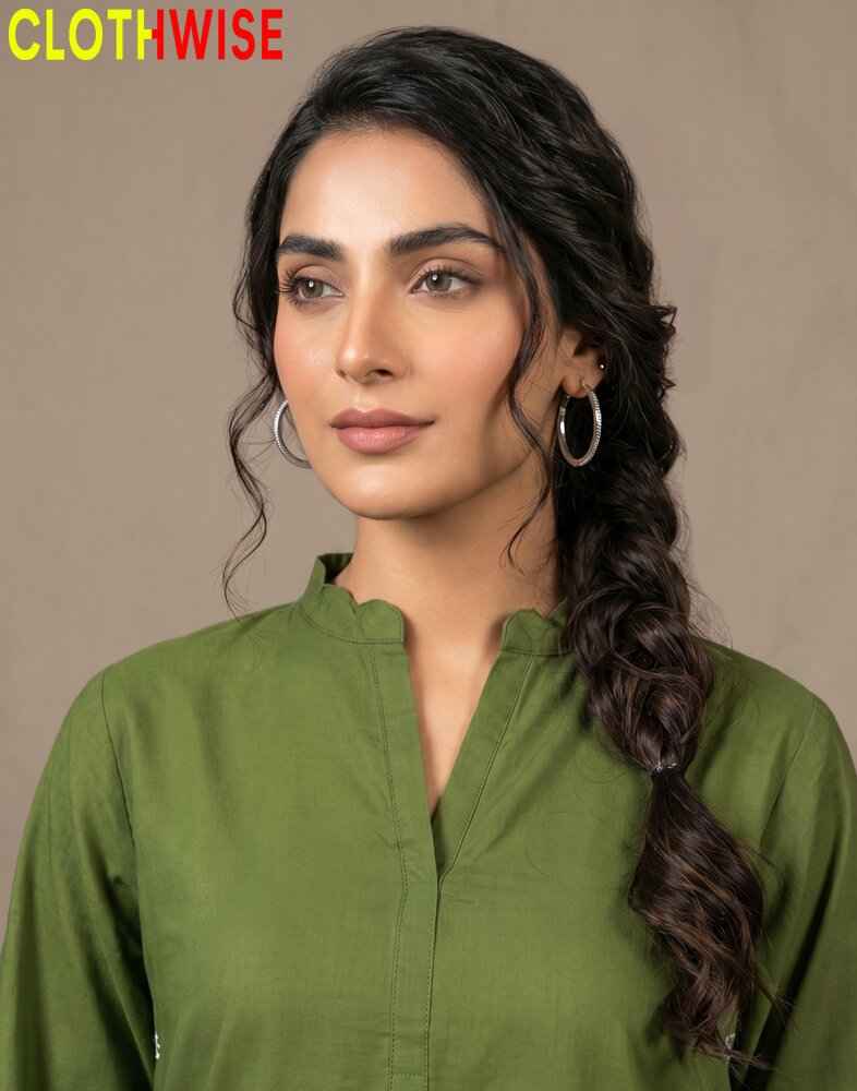 Woman wearing a green kurta with a plain background, featuring the brand 'Clothwise'.