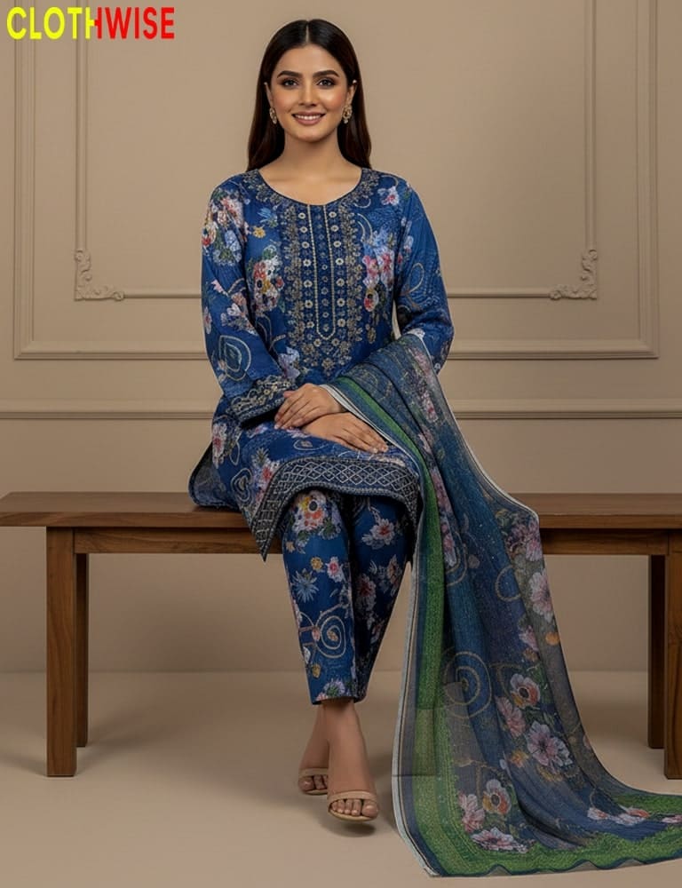 Woman wearing a blue floral dress with a matching dupatta sitting on a wooden bench.