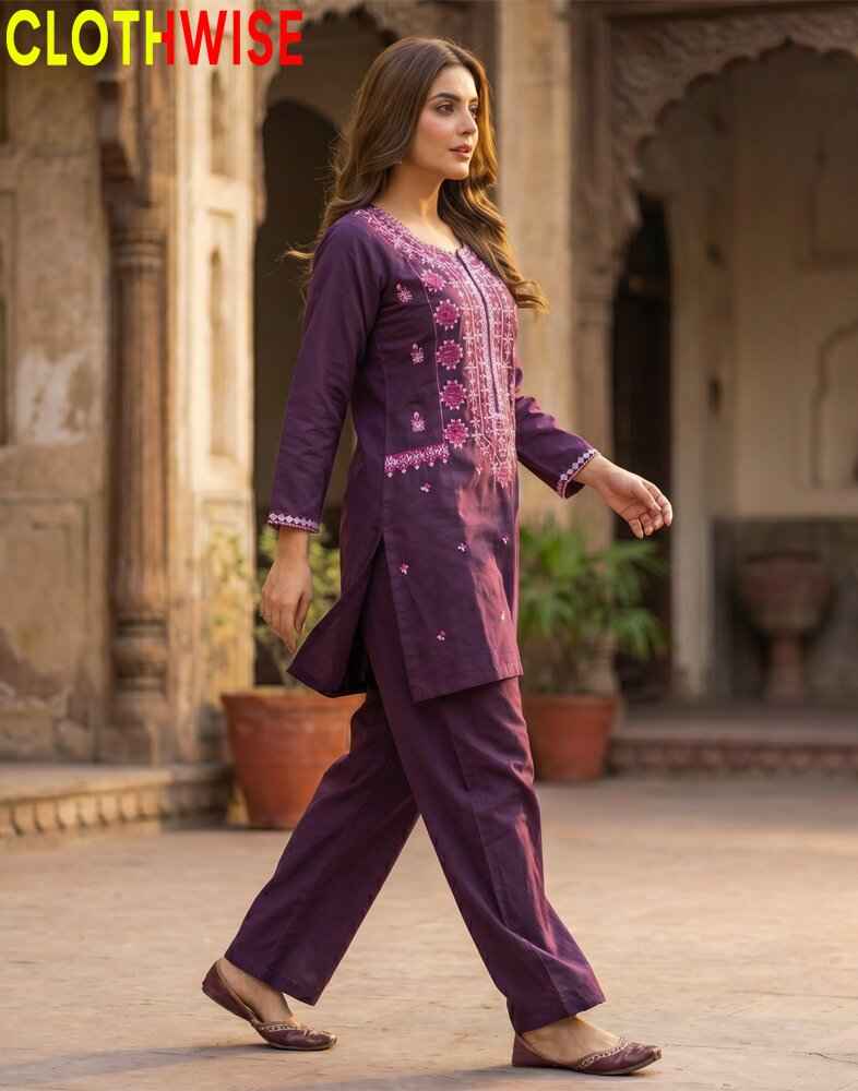 Woman wearing a purple embroidered outfit walking outdoors with 'CLOTHWISE' branding.