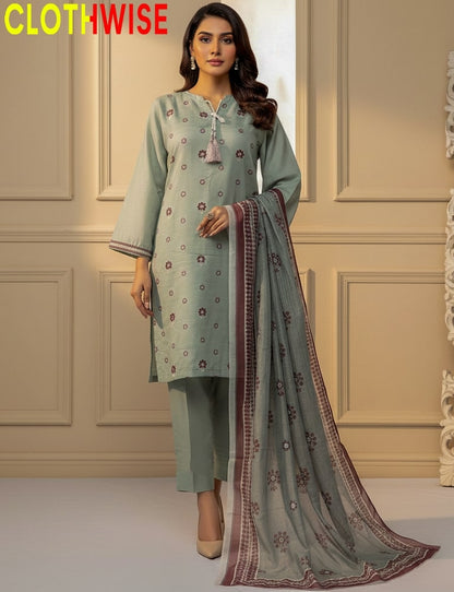 Woman wearing a light green traditional outfit with a matching dupatta in a neutral setting.