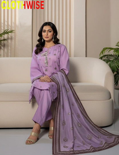 Woman in a purple traditional outfit sitting on a white couch with 'CLOTHWISE' branding.