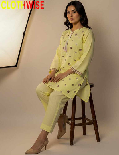 Woman in a yellow traditional outfit sitting on a stool with 'CLOTHWISE' branding.