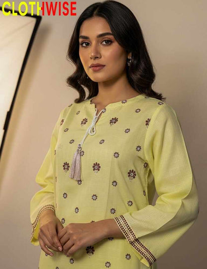 Woman wearing a yellow embroidered kurta with 'CLOTHWISE' branding.
