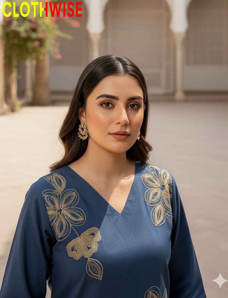 Woman wearing a blue top with gold embroidery in an outdoor setting, branded 'Clothwise'.