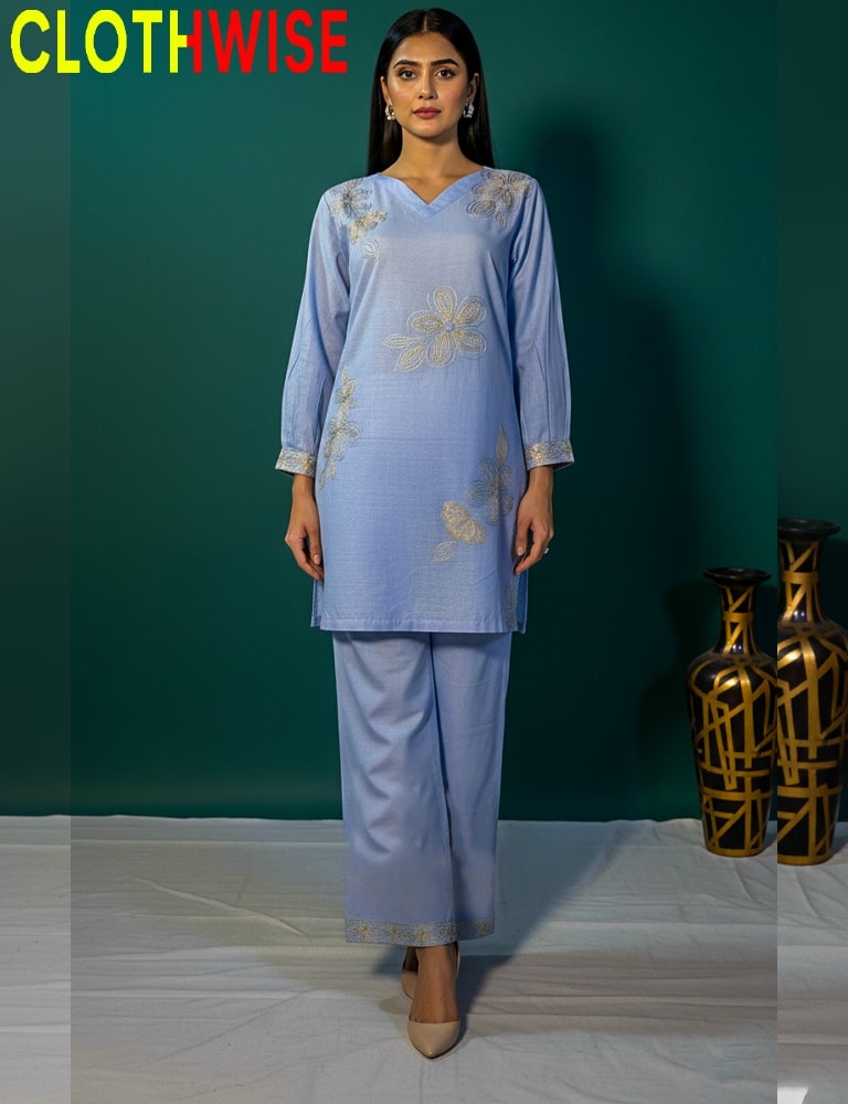 Woman wearing a light blue embroidered outfit with 'ClothWise' branding.