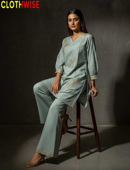 Woman in a light blue outfit sitting on a stool against a dark background with 'CLOTHWISE' branding.