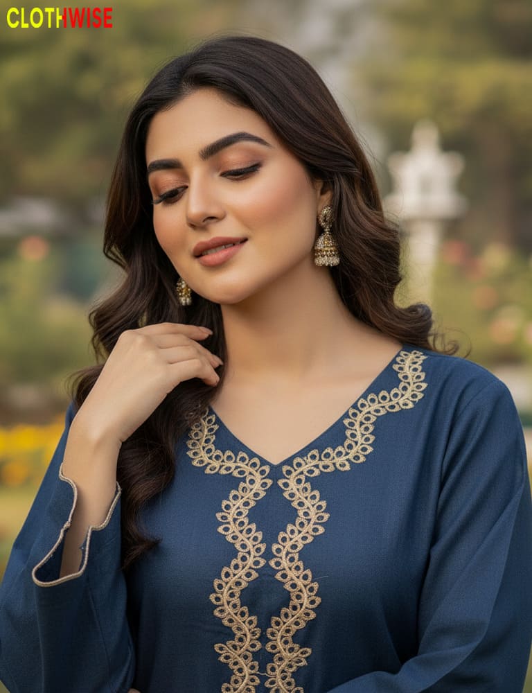 Woman wearing a blue embroidered dress with a blurred outdoor background